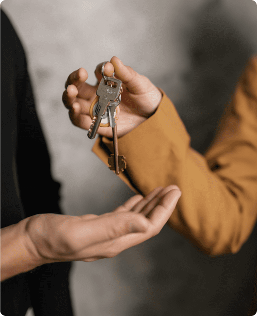 A homeowner happily hands the key to the agent from Suffolk County House Buyers. They are excited about selling their Long Island home quickly in Suffolk County, New York!